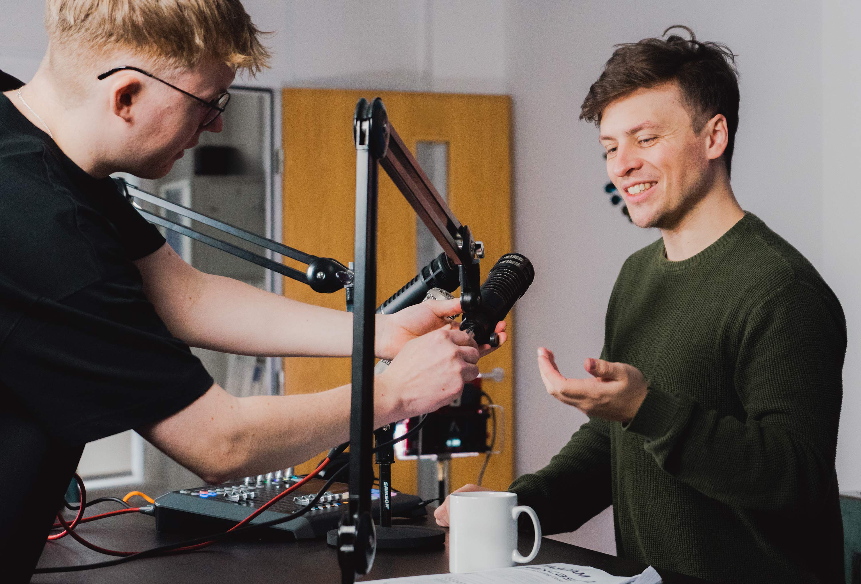 person setting up for podcast interview in studio.